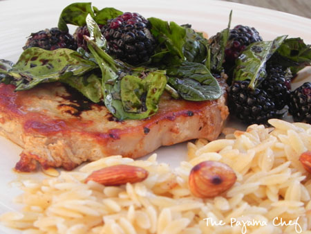 close up of Pork Chops with Balsamic Blackberry Salad + Orzo on a plate