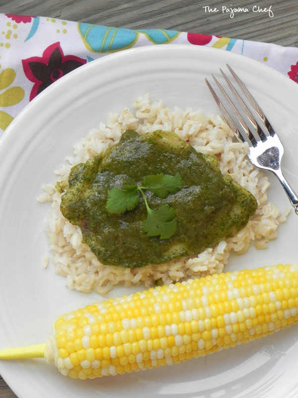 An easy baked tilapia dish jazzed up with a creamy, dreamy green sauce... this simple meal is fresh and flavorful, perfect for summer! #bookclubcookbookCC