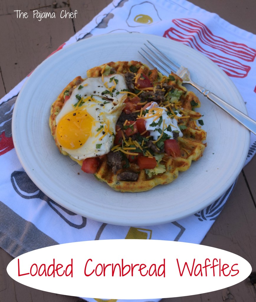 Cornbread waffles filled with cheese, peppers, and onions are loaded with sausage, tomatoes, a creamy avocado spread, and a fried egg for an impressive brunch like no other! This is a fantastic restaurant-worthy dish that's easy to make at home. You'll be sure to love it! #secretrecipeclub